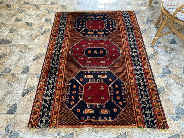 Vintage Hand-Knotted Turkish Area Rug | 4.1 x 5.6 ft | Distressed Geometric Rug